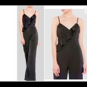 Harlyn black wide leg jumpsuit with delicate button & ruffle detail